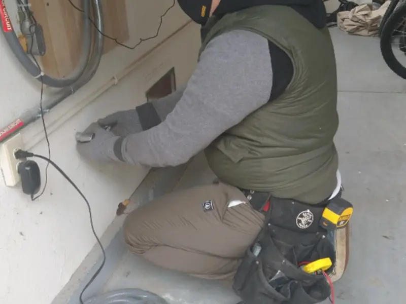 Electrician performing outlet wiring in a Fishers garage